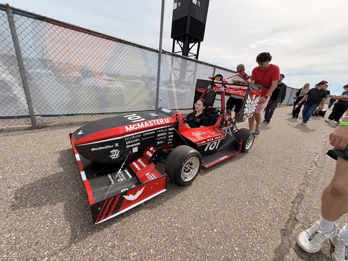 Car 101 being pushed to technical inspection with the driver seated